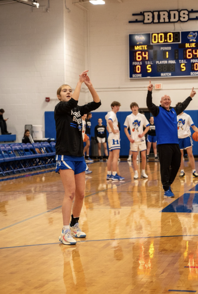 Boys Varsity Head Coach Kevin Listerman celebrates as Maddy Lickert (10) hits the winning shot to win the 3-point contest. (Liam Downie)
